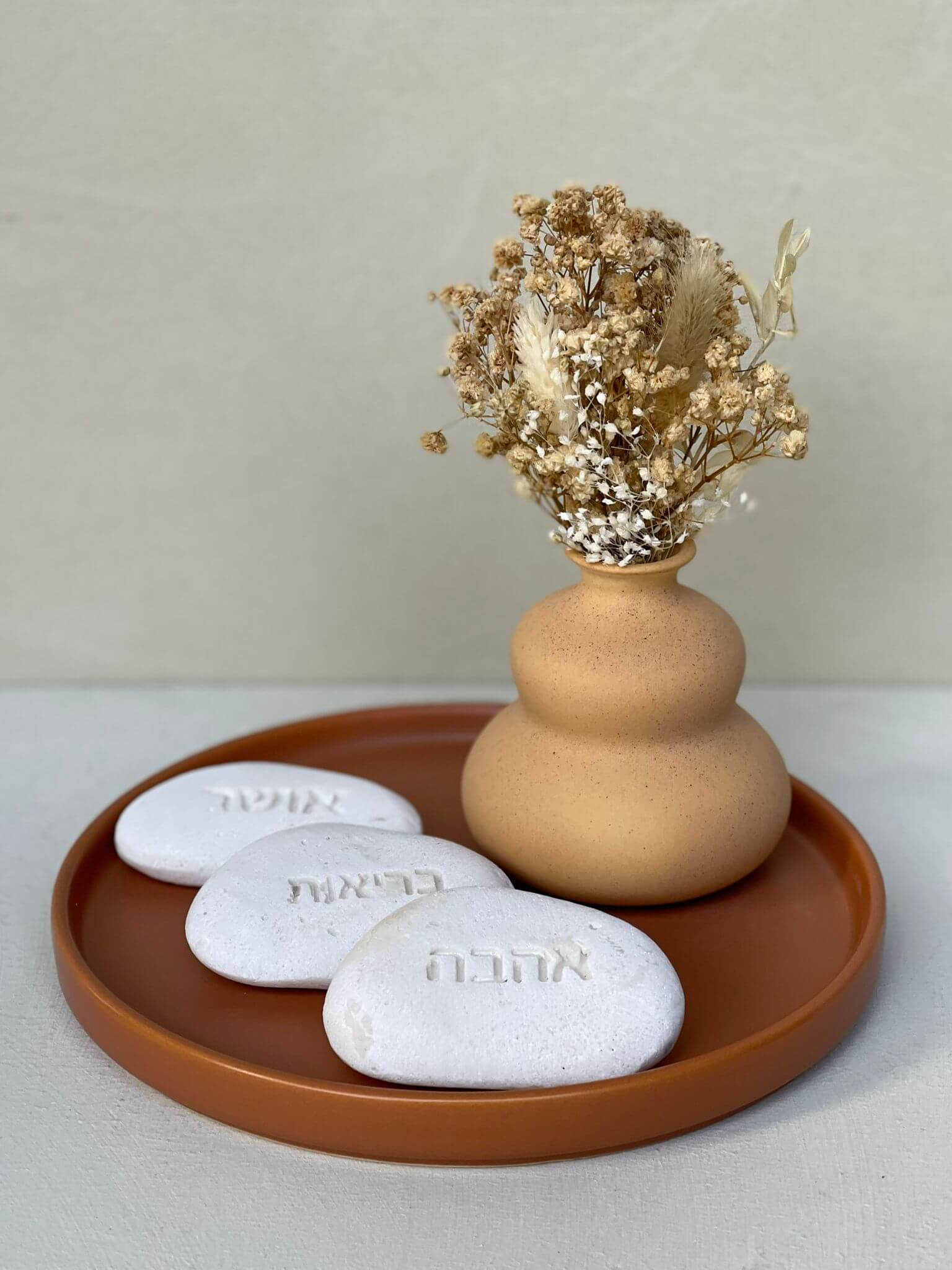 vase on tray with dried flowers 